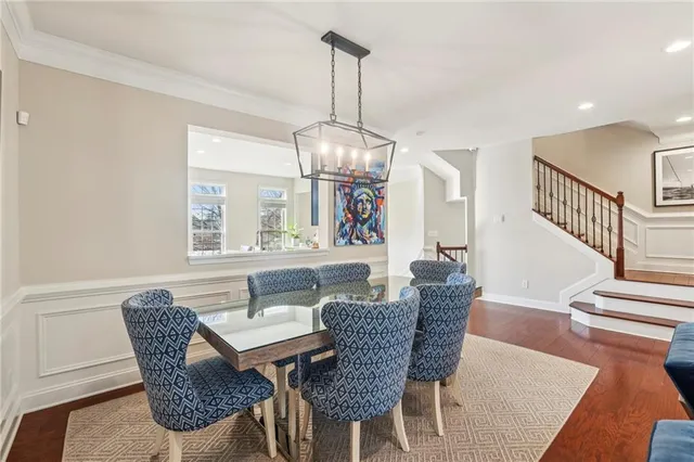 a dining room with furniture a chandelier and wooden floor