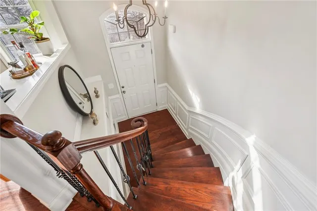 a view of staircase with railing and a rug