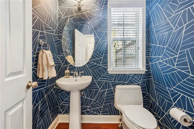 a bathroom with a sink a toilet and mirror