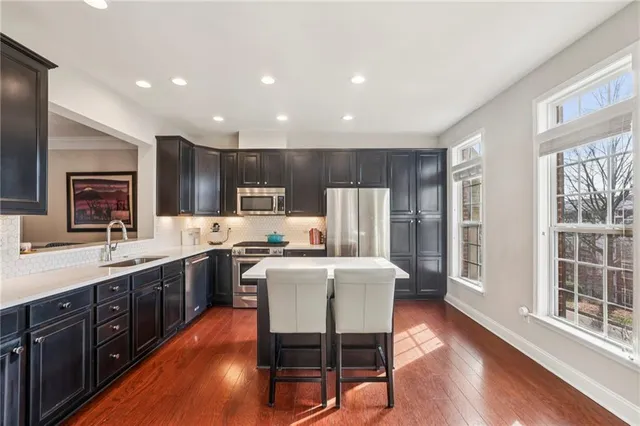 a large kitchen with a table and chairs