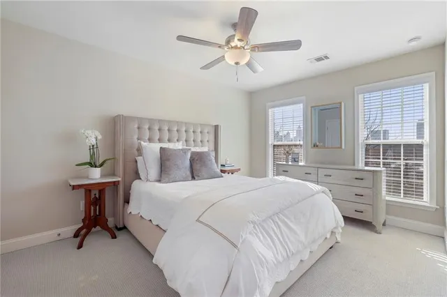 a bedroom with a bed a chandelier and a window