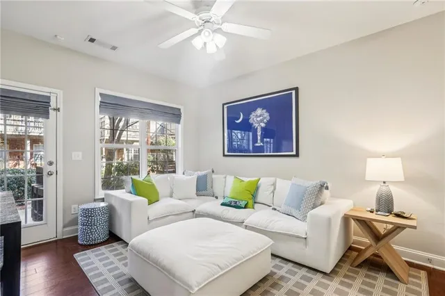 a living room with furniture and wooden floor