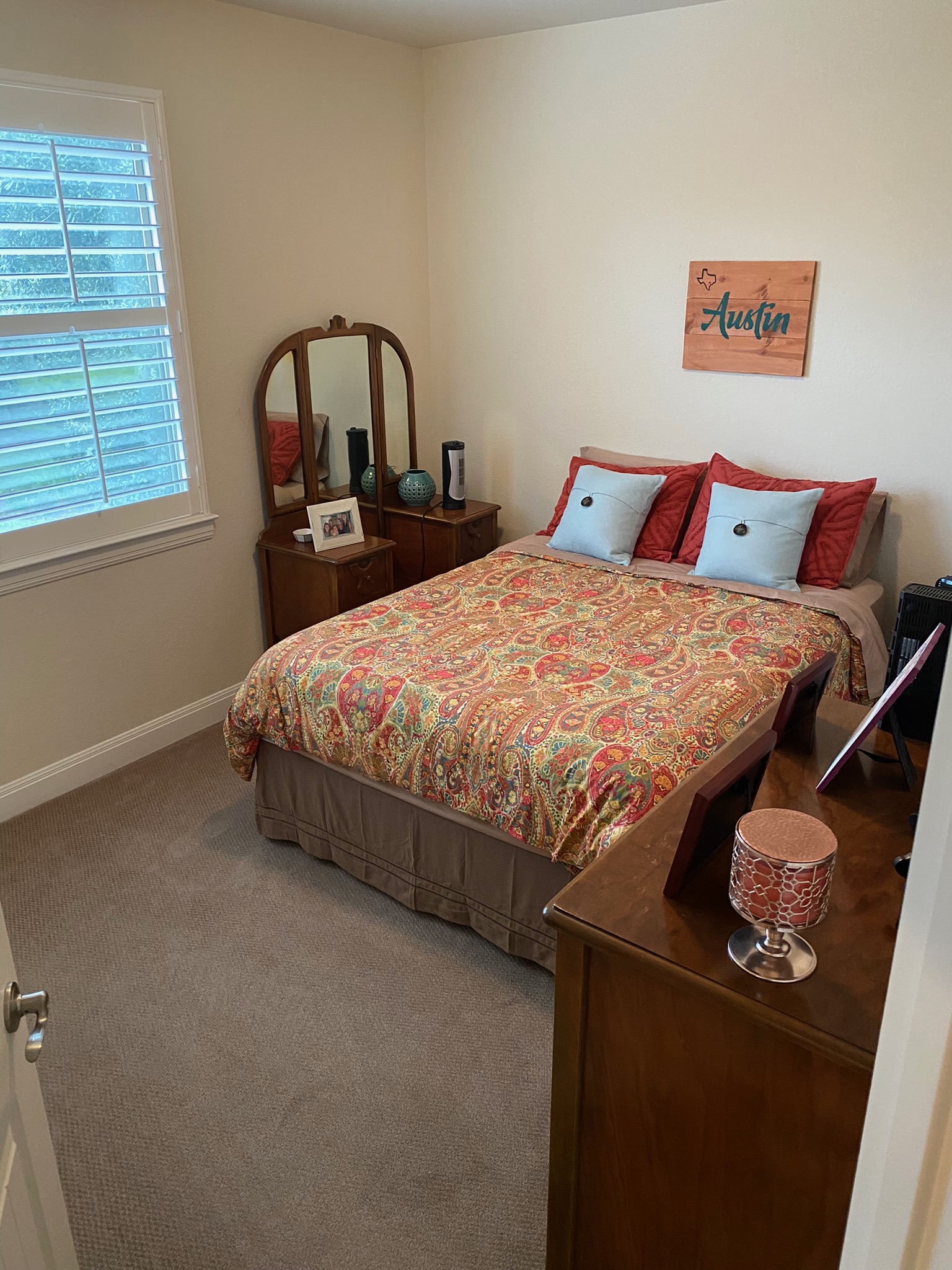 6708 Menchaca Road, Unit 25 Austin, TX 78745 - Photo 19 of 19 A quiet bedroom features neutral walls, classic baseboards, and soft carpeting.