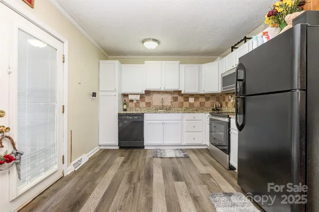 a kitchen with a refrigerator and a stove