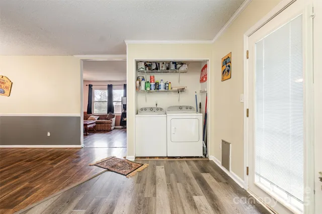 a view of a livingroom with wooden floor and cabinet