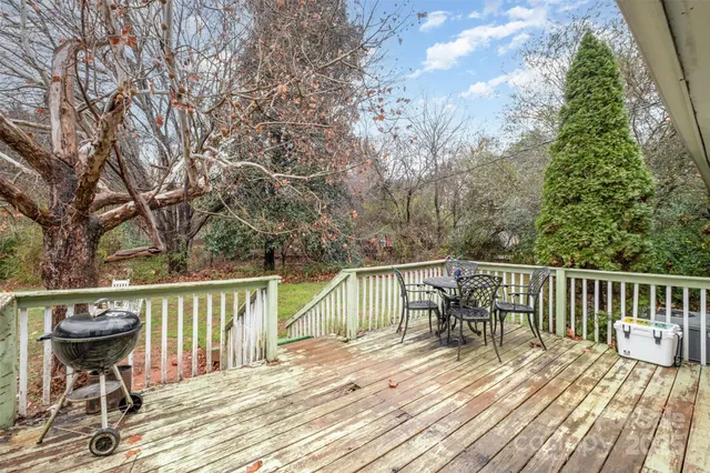 a view of balcony with wooden floor and outdoor seating