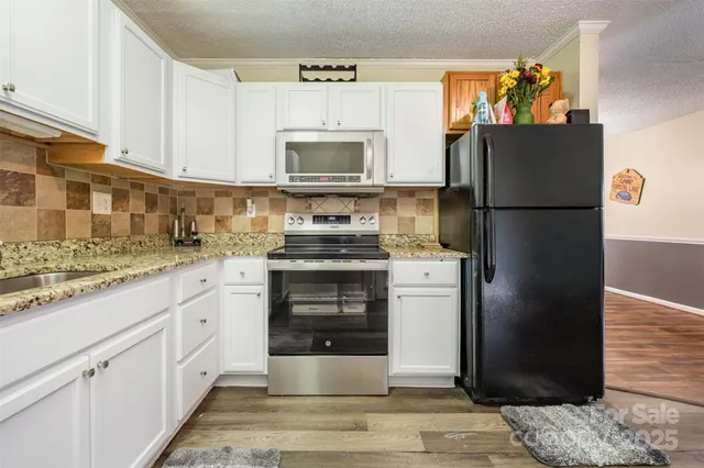 a kitchen with a refrigerator stove and sink