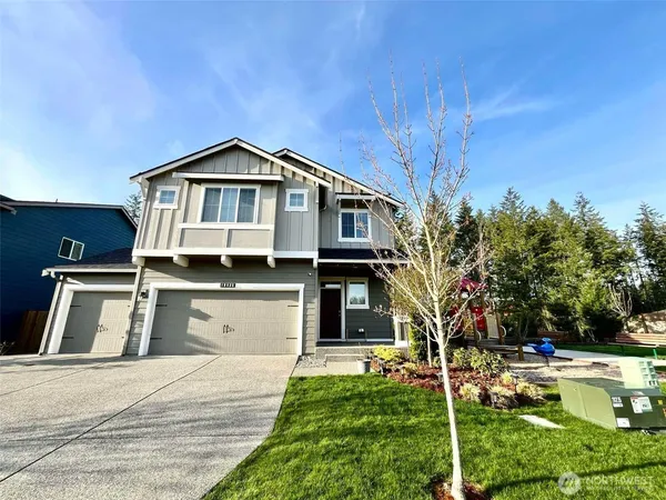 a front view of a house with a yard