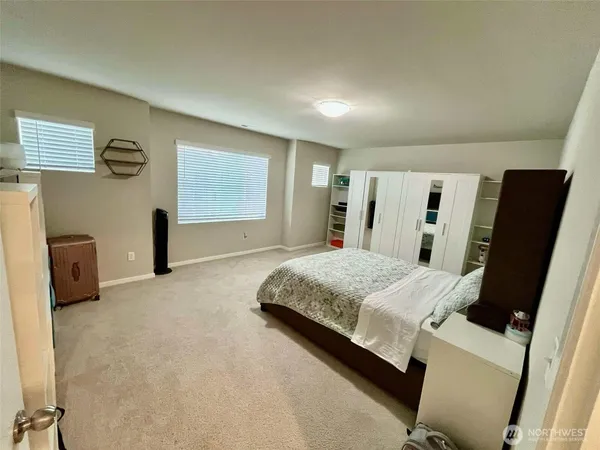 an empty room with windows and closet