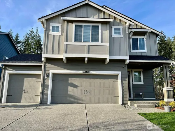 a front view of a house with garage