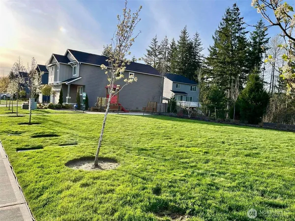 a backyard of a house with table and chairs