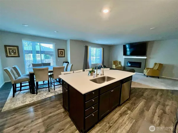 a kitchen with a sink and living room