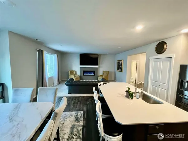 a large kitchen with a table and chairs