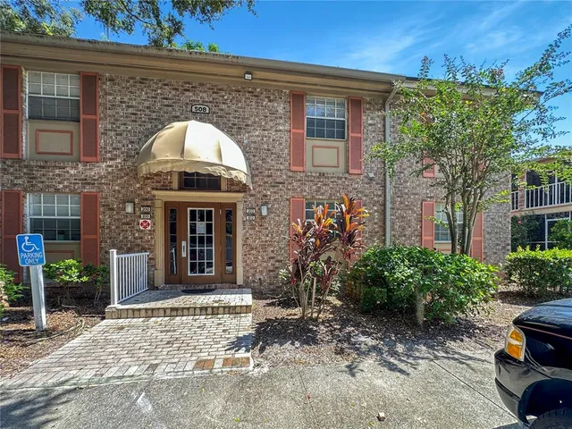 a view of house with yard and outdoor seating