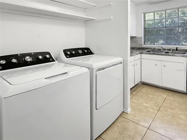 a view of a balcony with floor to ceiling windows and wooden fence