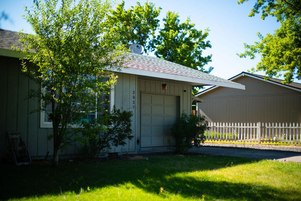 3037 Clearbrook Place Malin, OR 97632 - Photo 2 of 30 a view of a house with a small yard plants and large tree
