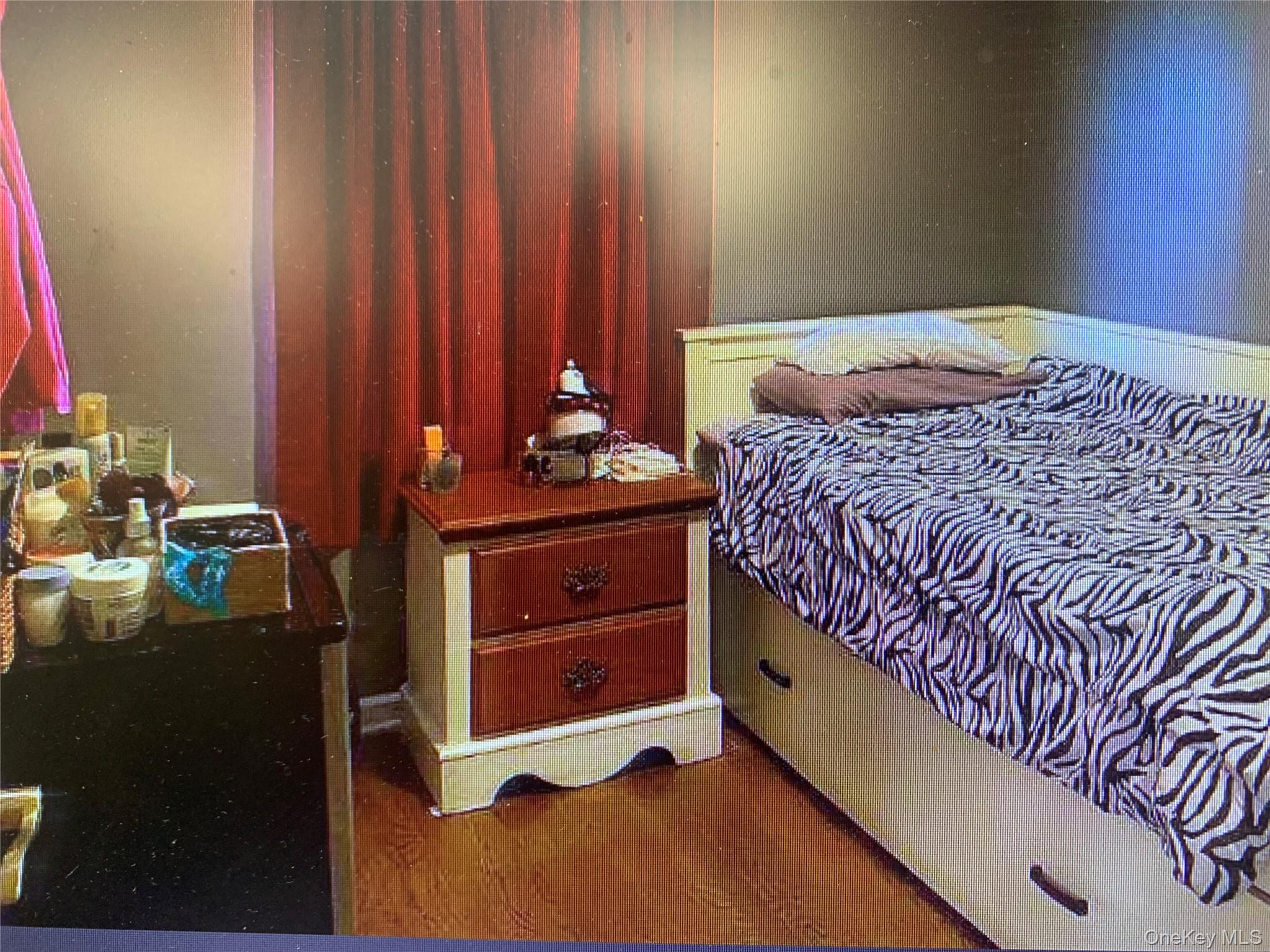 54 Robert Street Freeport, NY 11520 - Photo 5 of 11 a bedroom with a bed and a dresser