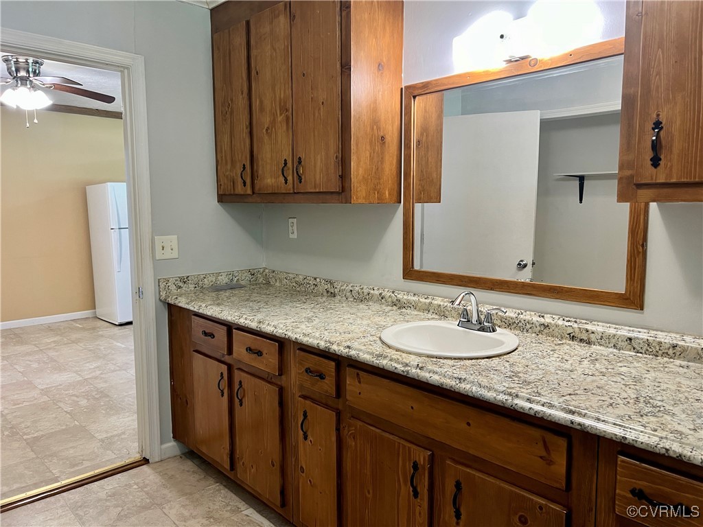2733 Indian Oak Road Crewe, VA 23930 - Photo 18 of 31 a bathroom with a granite countertop sink and a mirror