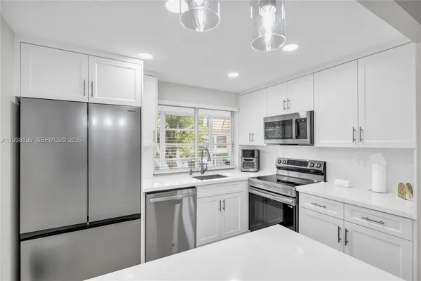 a spacious bathroom with a sink and a mirror