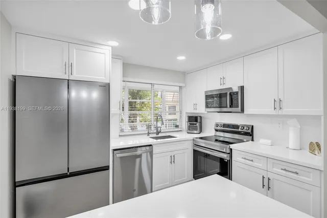 a spacious bathroom with a sink and a mirror