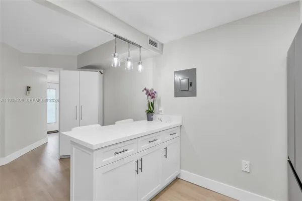 a living room with furniture a flat screen tv and a large window