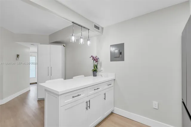a living room with furniture a flat screen tv and a large window