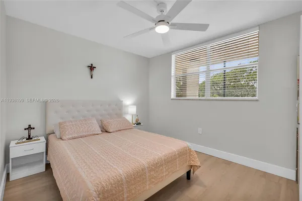 a bedroom with a bed and a ceiling fan