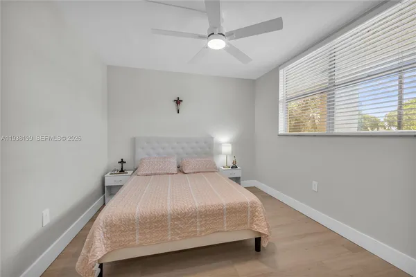 a bedroom with a bed and a ceiling fan