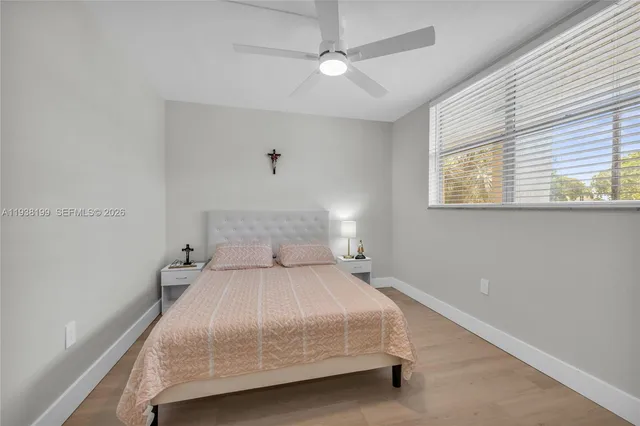 a bedroom with a bed and a ceiling fan