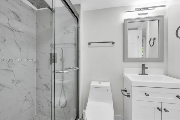 a bathroom with a sink toilet and shower