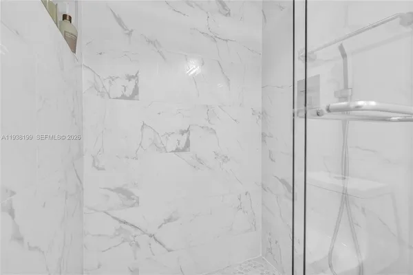 a living room with patio furniture and a floor to ceiling window