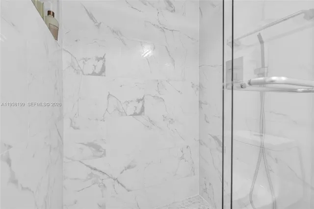 a living room with patio furniture and a floor to ceiling window