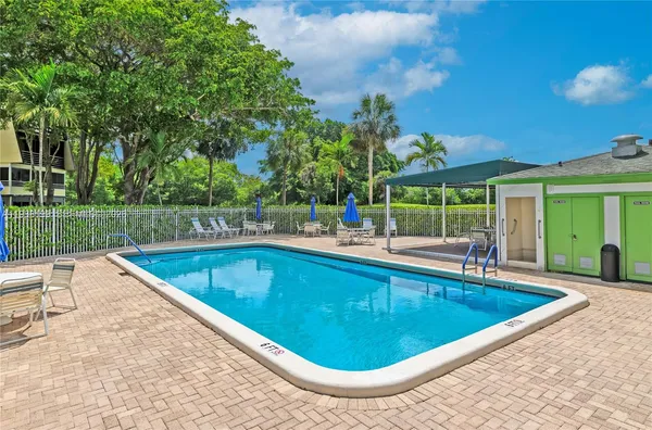 swimming pool view with a seating space