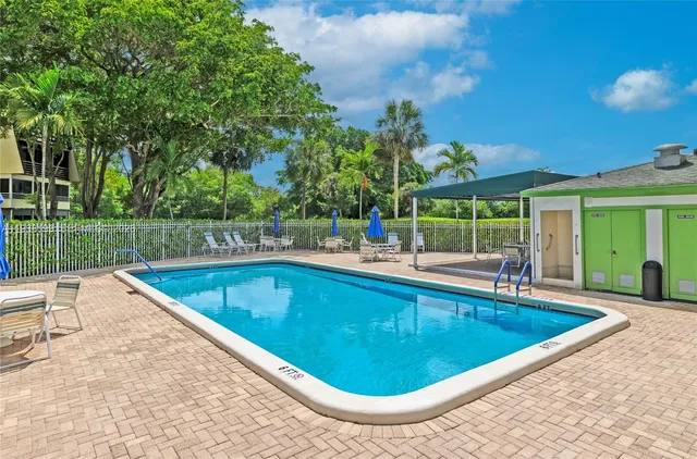 swimming pool view with a seating space