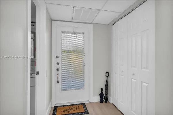 a kitchen with a dining table chairs refrigerator and cabinets