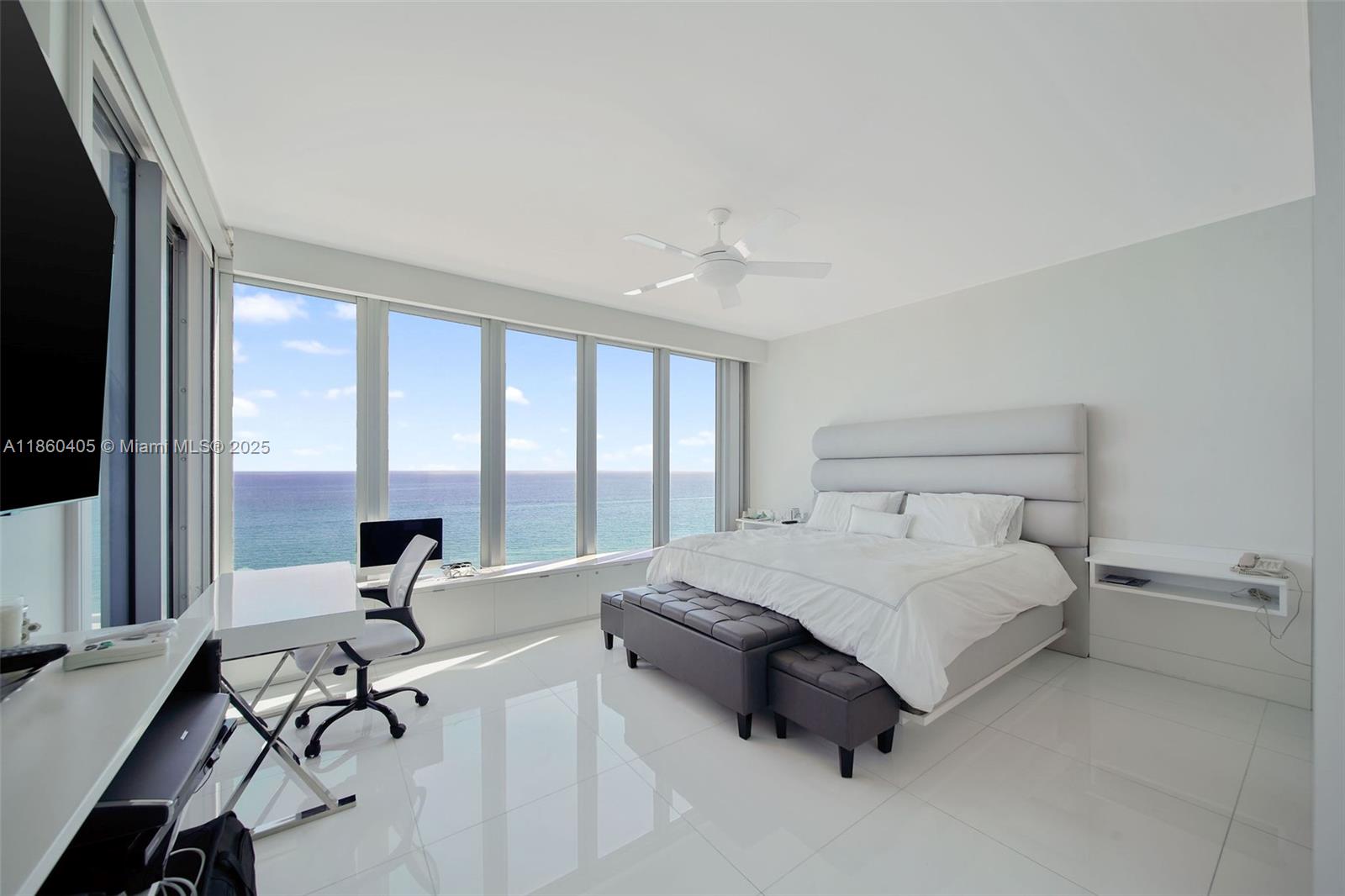 6899 Collins Avenue, Unit 1905 Miami Beach, FL 33141 - Photo 11 of 29 a spacious bedroom with a bed and large windows