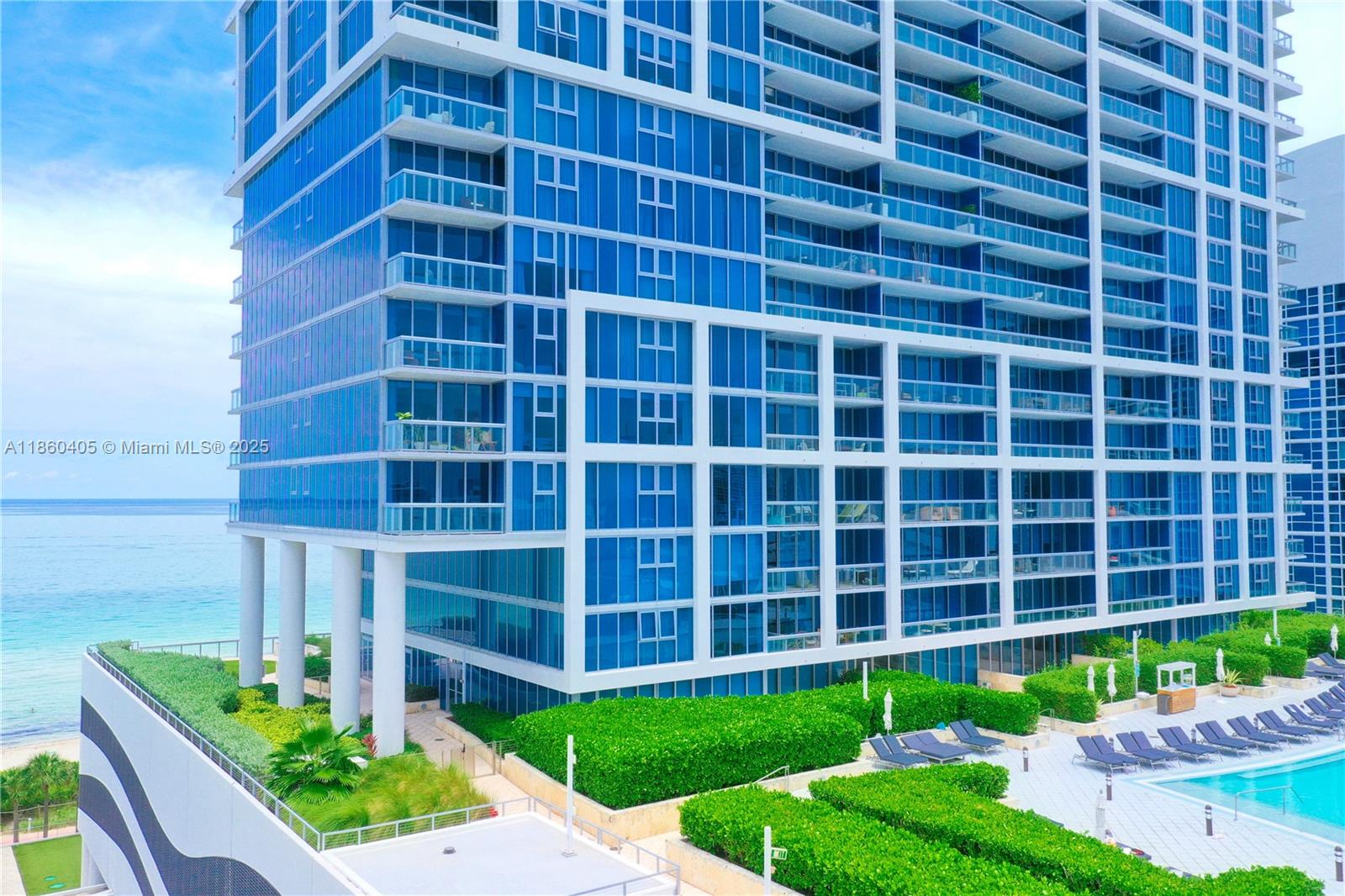 6899 Collins Avenue, Unit 1905 Miami Beach, FL 33141 - Photo 18 of 29 a view of a building with a yard