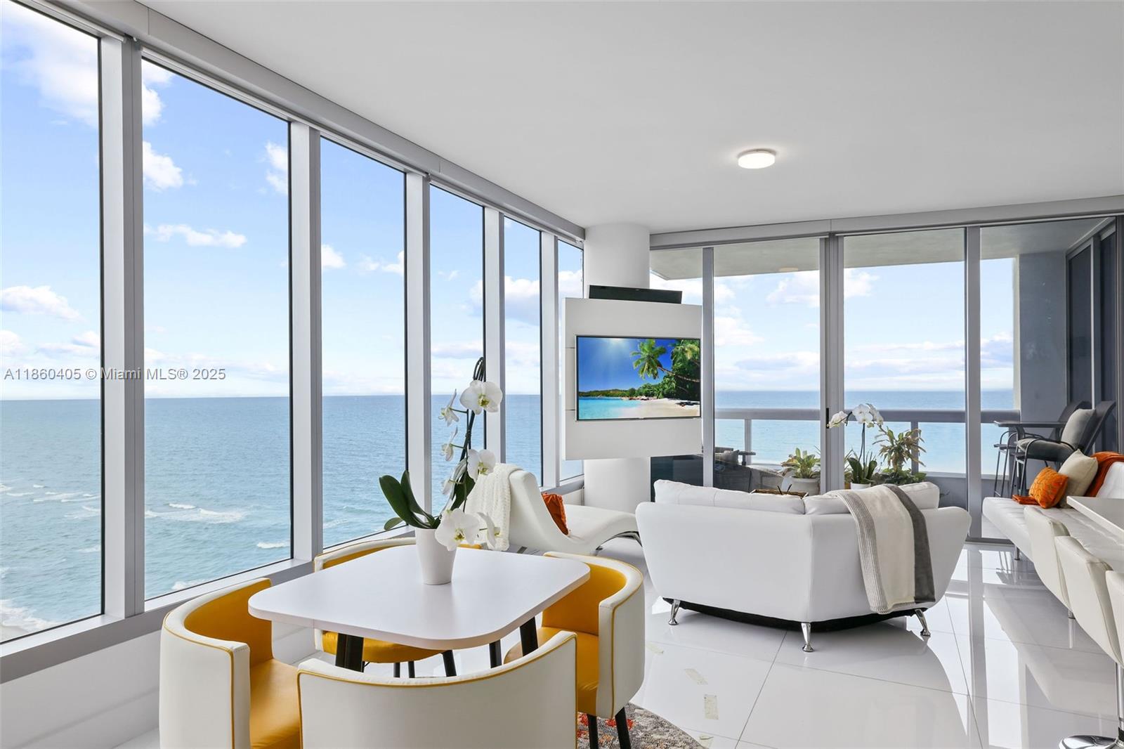 6899 Collins Avenue, Unit 1905 Miami Beach, FL 33141 - Photo 2 of 29 a living room with furniture and a large window