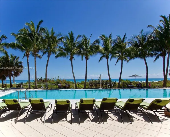 a view of a house with floor to ceiling windows and dining table