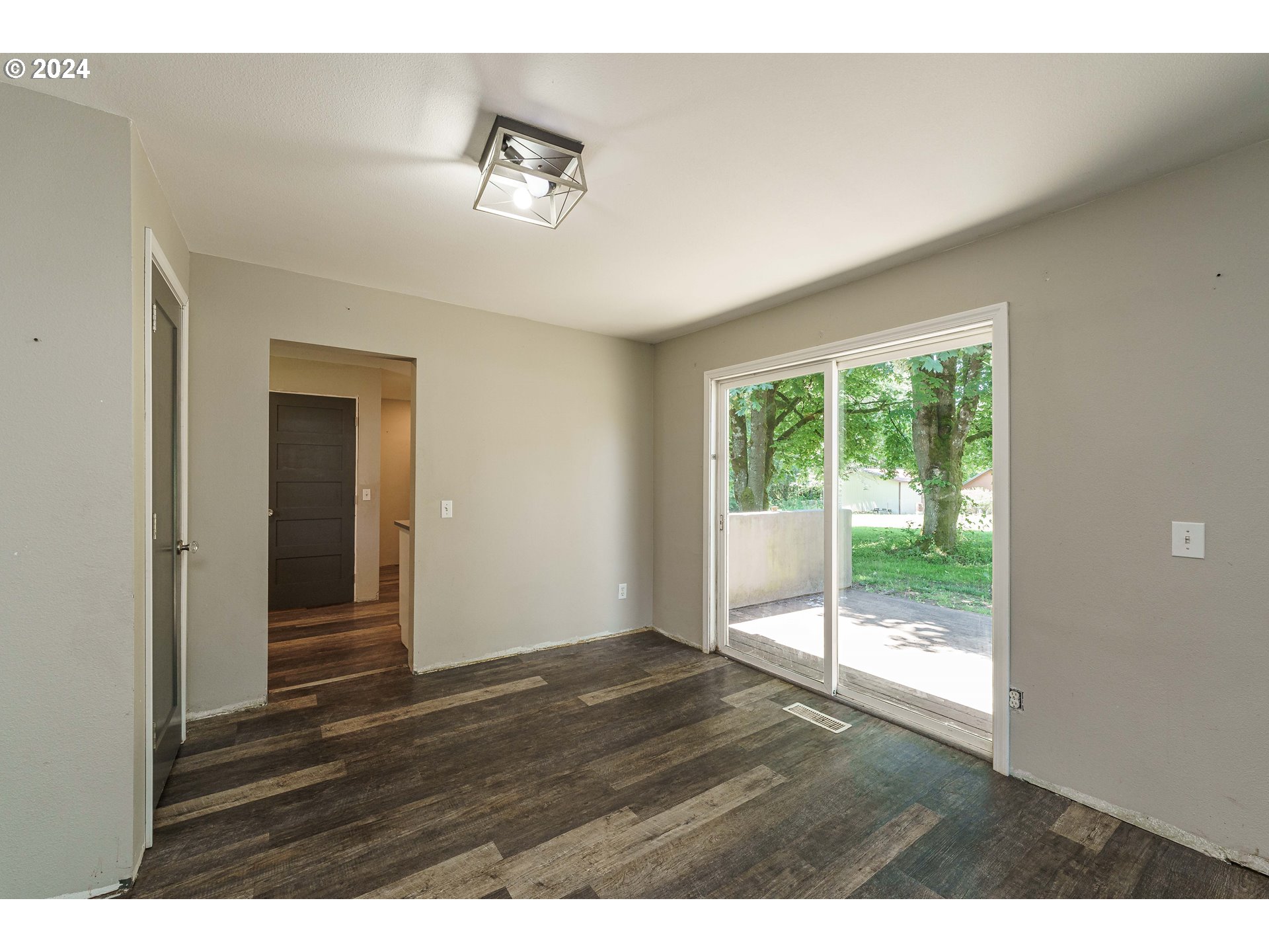 19625 Southeast Jacoby Road Sandy, OR 97055 - Photo 12 of 47 a view of an empty room with wooden floor and a window