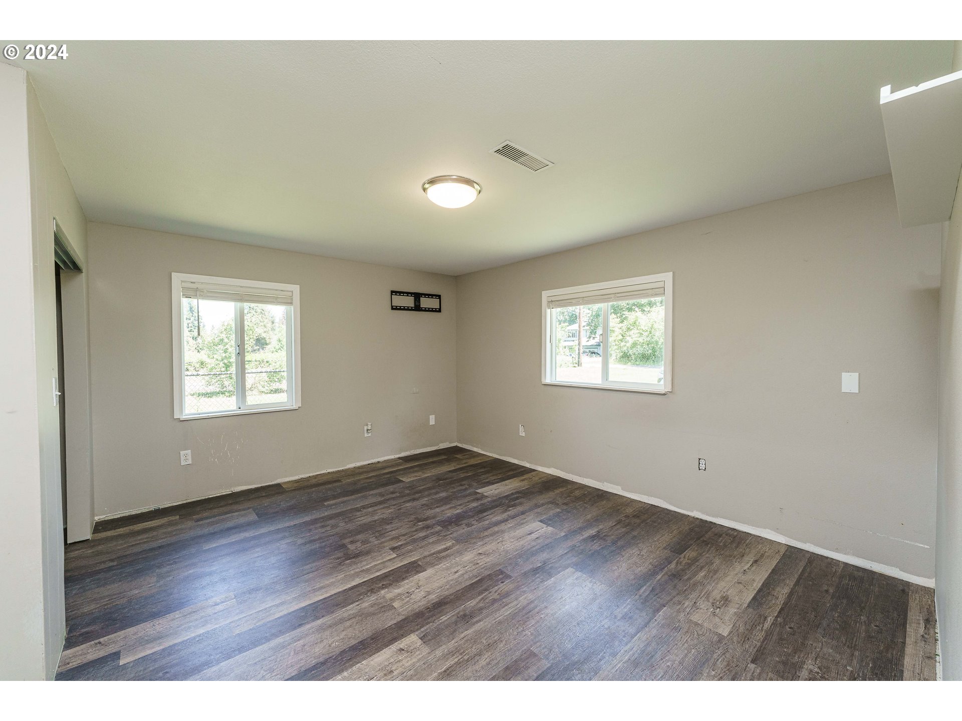 19625 Southeast Jacoby Road Sandy, OR 97055 - Photo 13 of 47 an empty room with wooden floor and windows