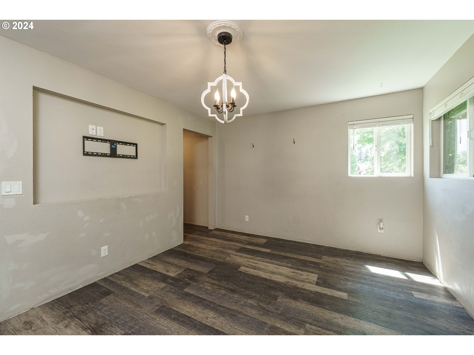 19625 Southeast Jacoby Road Sandy, OR 97055 - Photo 18 of 47 a view of an empty room with wooden floor and a window