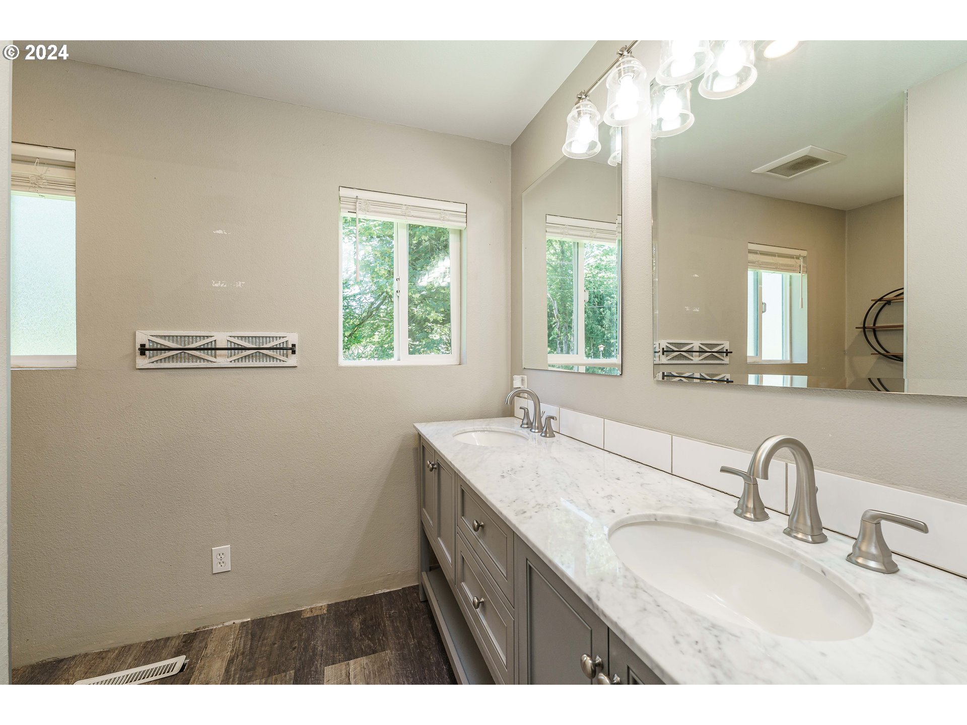 19625 Southeast Jacoby Road Sandy, OR 97055 - Photo 21 of 47 a bathroom with a granite countertop sink a large mirror and a window