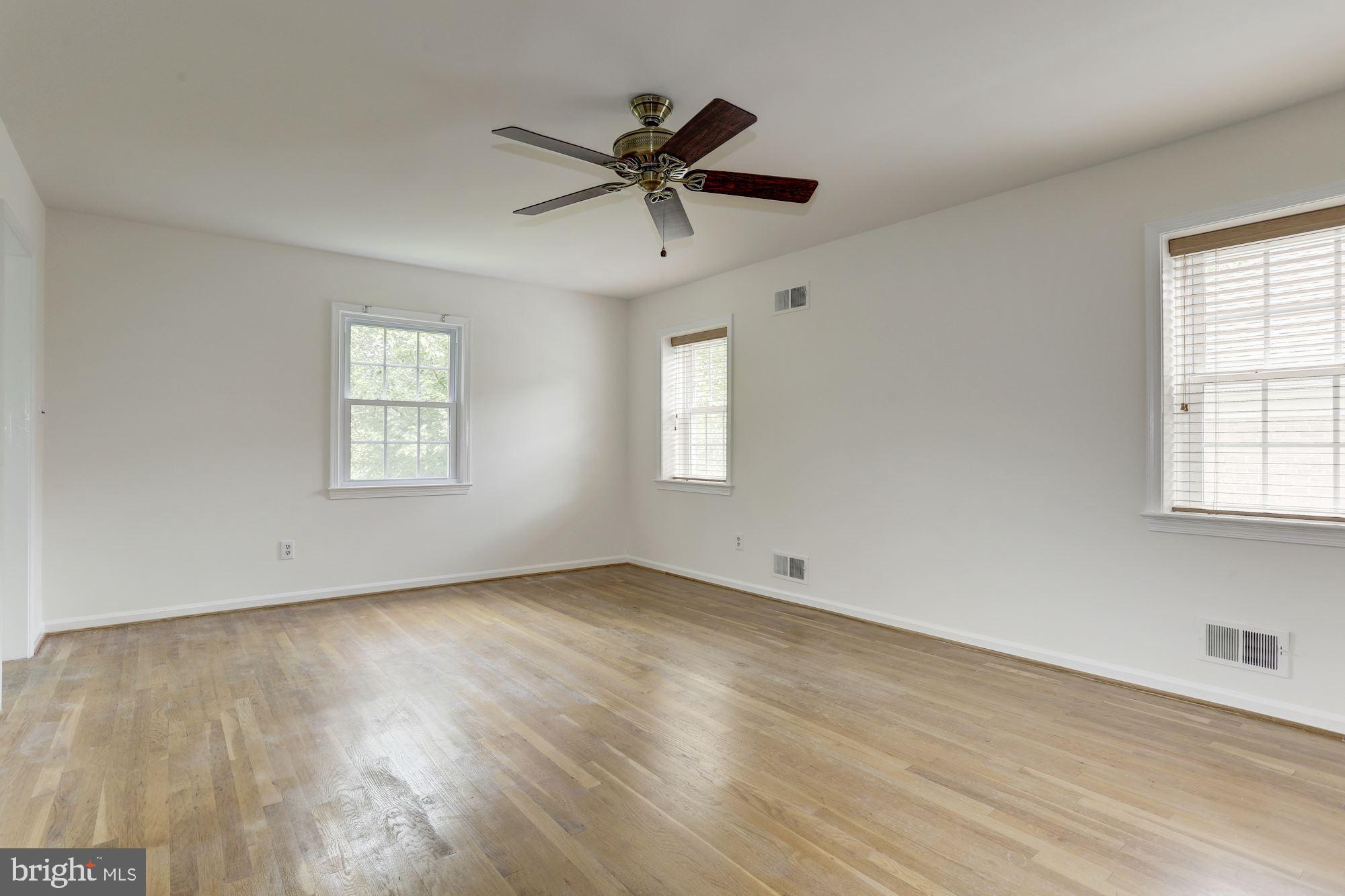 10239 Gainsborough Road Potomac, MD 20854 - Photo 13 of 21 a view of empty room with wooden floor and fan