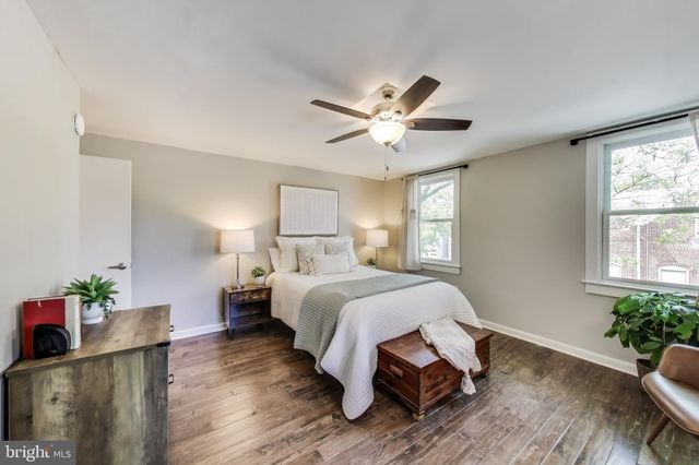 a bed room with a bed window and a chair