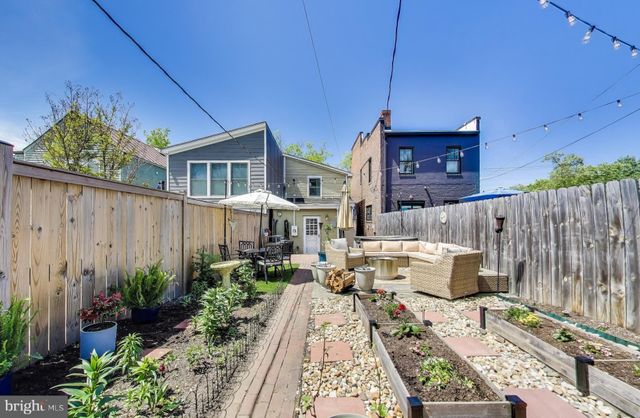 a view of a backyard with sitting area