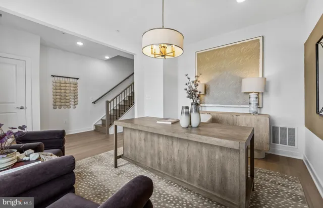 a dining room with furniture and a chandelier