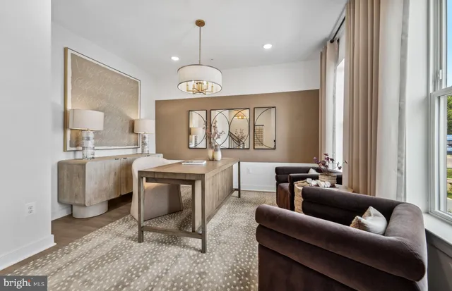 a living room with furniture a dining table and a chandelier