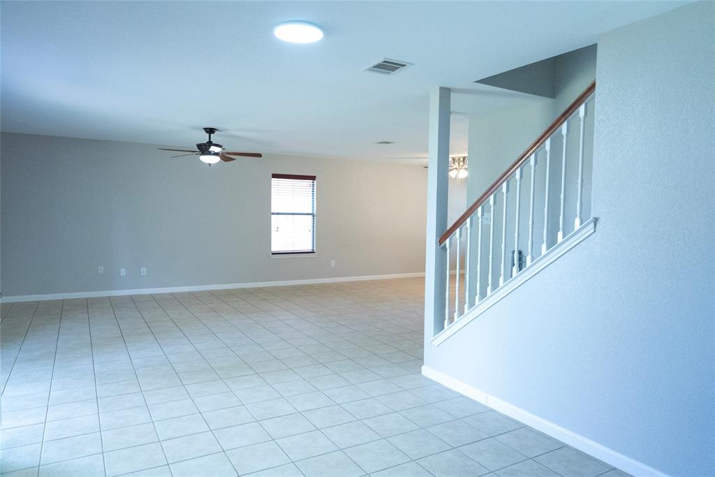 8805 Graywolf Ridge Trail Fort Worth, TX 76244 - Photo 21 of 23 Spacious interior featuring tile flooring, a ceiling fan, and a window with blinds