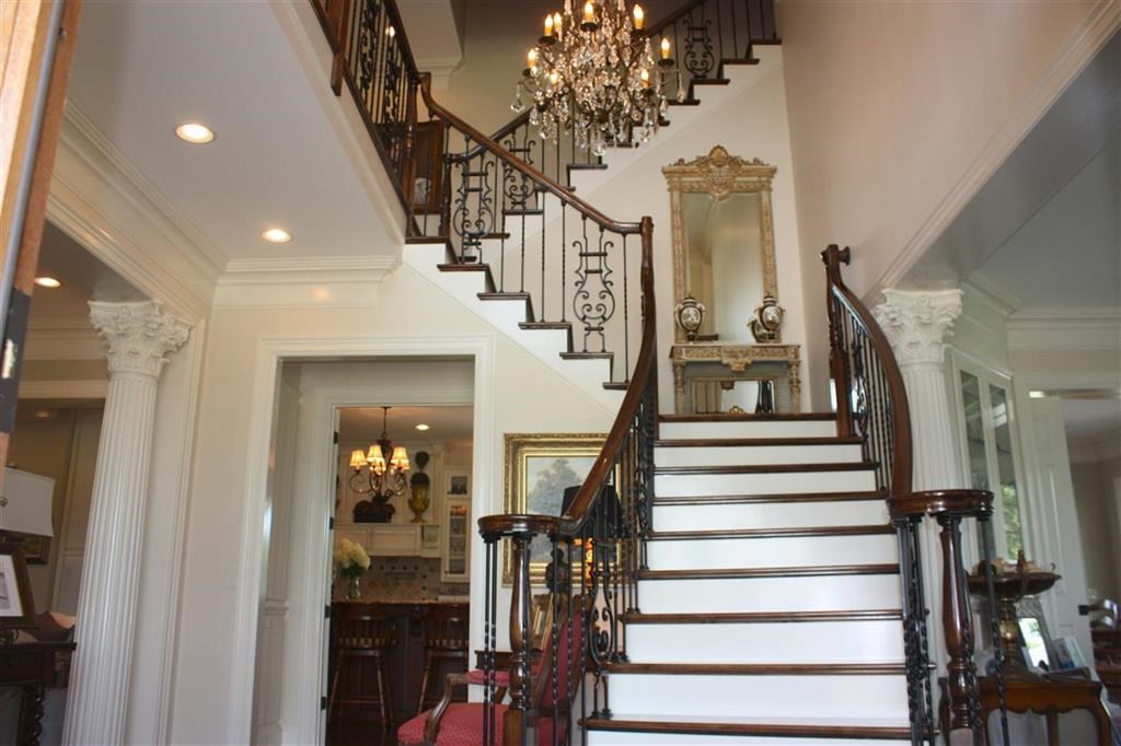 288 Irvin Road Stantonville, TN 38379 - Photo 6 of 25 Grand Staircase features custom wrought iron spindles with maple handrailing